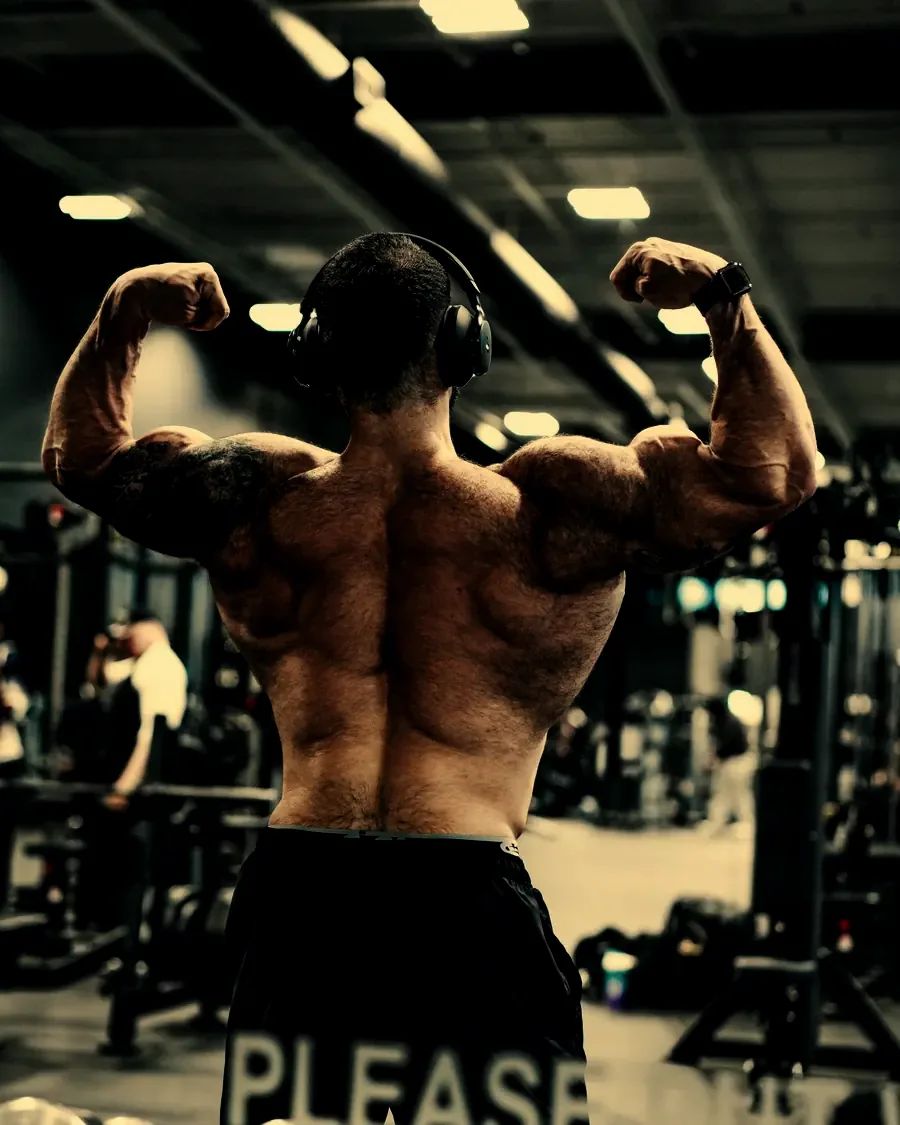 Justin holding a back double biceps pose