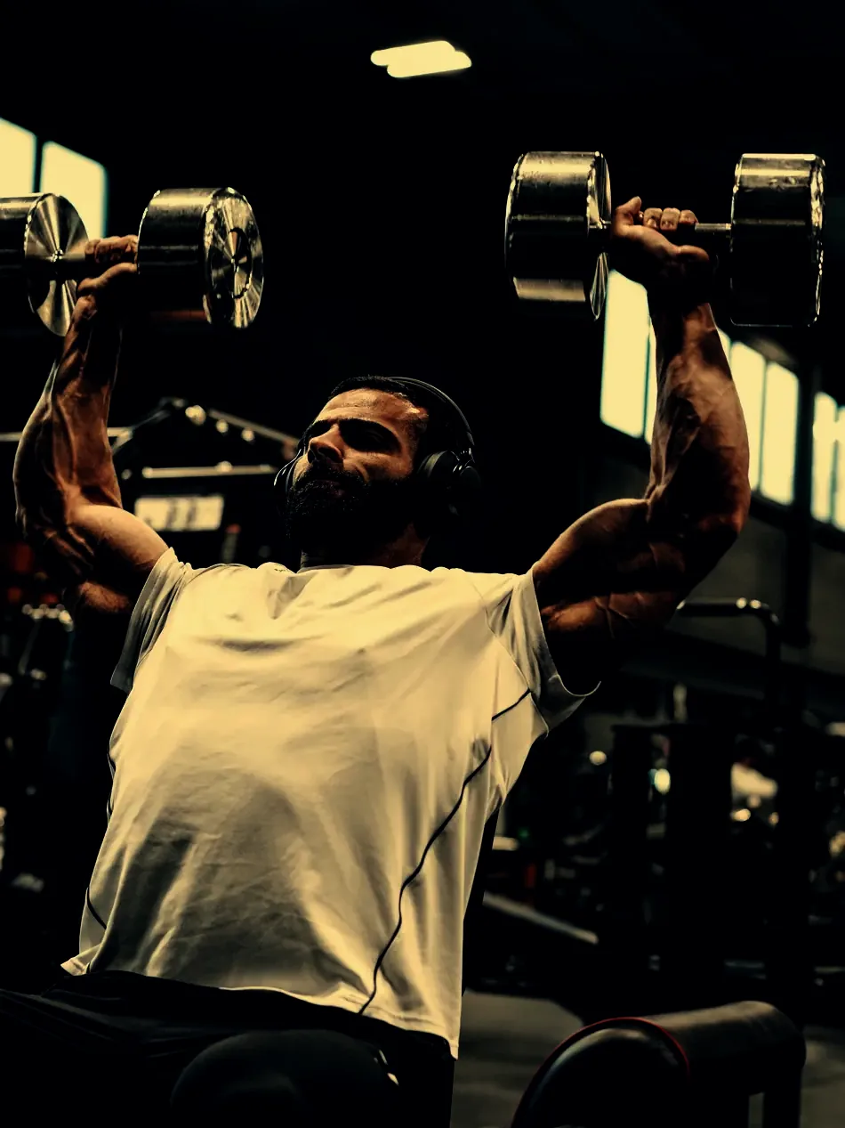 Justin pressing dumbbells overhead