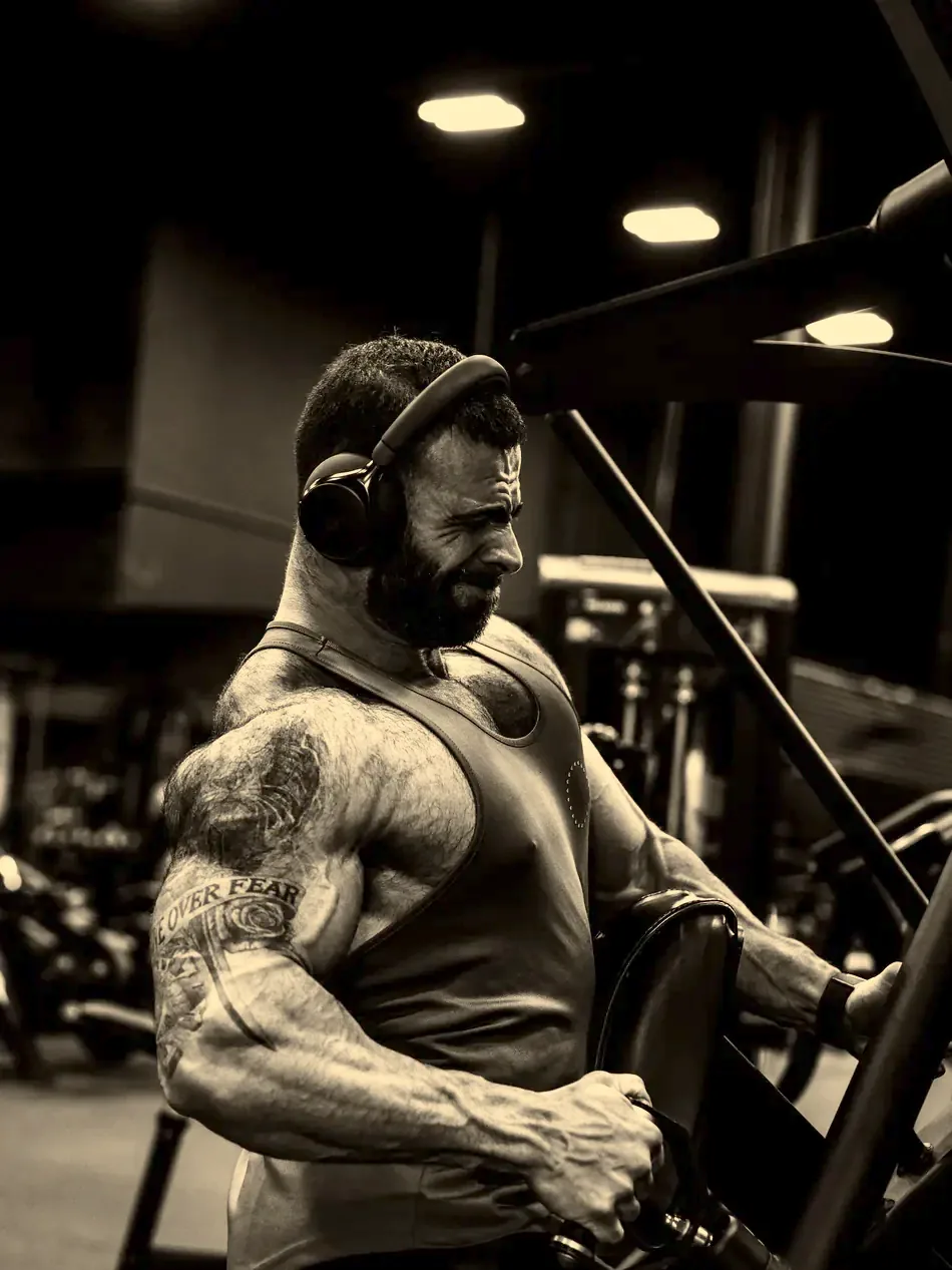 Justin walking through the gym carrying two plates